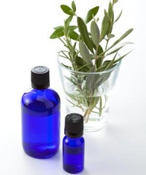 blue essential oil bottles and olive leaves