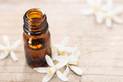 Neroli essential oil bottle and flowers